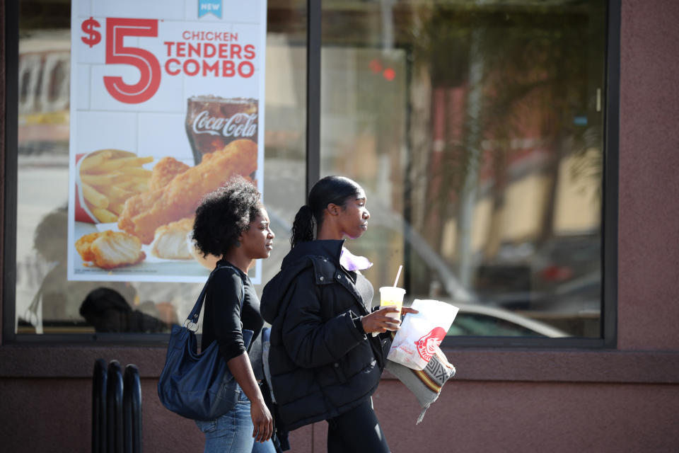 People carry food near a Wendy's fast food restaurant in Los Angeles, California U.S. November 7, 2017. REUTERS/Lucy Nicholson