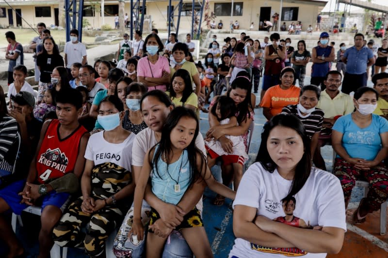 Residents displaced by Taal Volcano's eruption attend a Catholic mass in an evacuation center