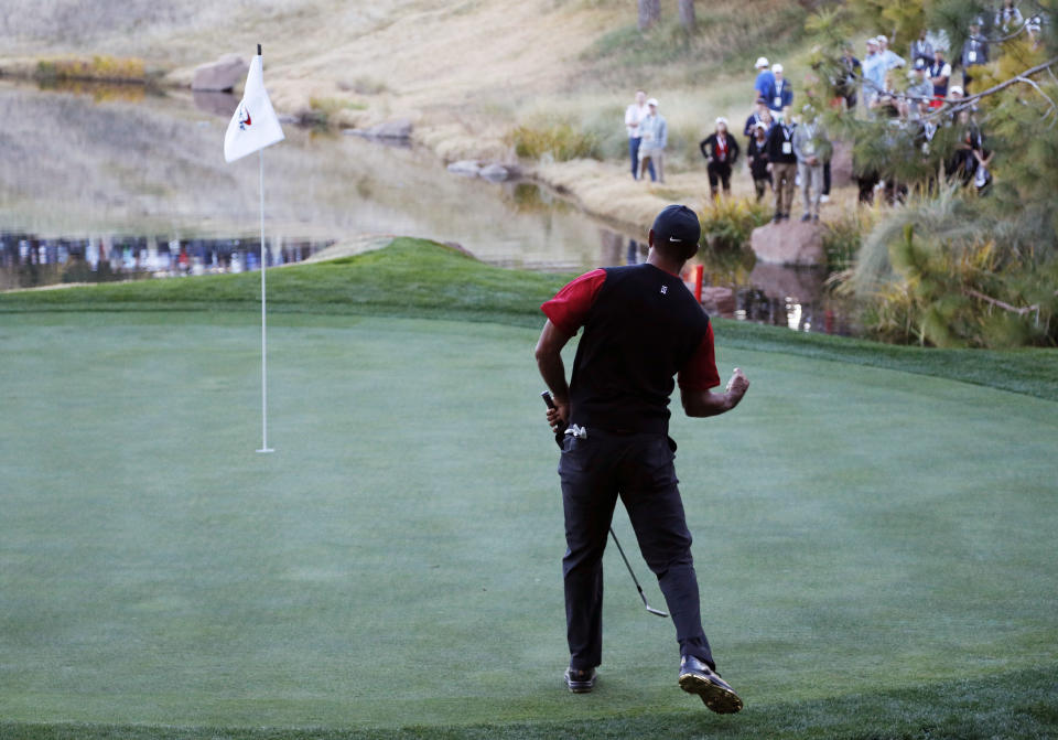 FILE - In this Nov. 23, 2018, file photo, Tiger Woods celebrates after making a chip into the 17th hole during a golf match against Phil Mickelson at Shadow Creek golf course in Las Vegas. Shadow Creek is back in the spotlight this week as it hosts the CJ Cup, typically played in South Korea. (AP Photo/John Locher, File)