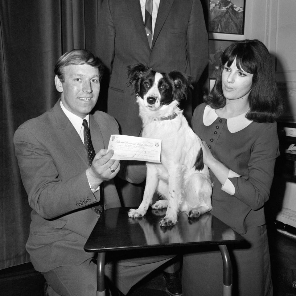 David Corbett, (26), a lighterman of Upper Norwood, London holds a cheque for 500 given to him by Bob Hales, Director of Gilletts UK Marketing, the reward having been offered by the Gillette Safety Razor Company for the recovery of the World Cup soccer trophy. Pictured is Mr Corbett with his wife Jeanne and their dog 