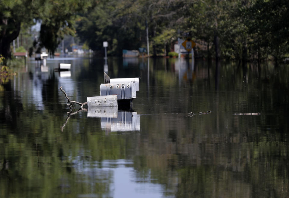 Rows of mailbox protrude through floodwaters in the aftermath of Hurricane Florence in Nichols, S.C., Friday, Sept. 21, 2018. Virtually the entire town is flooded and inaccessible except by boat, just two years after it was flooded by Hurricane Matthew. (AP Photo/Gerald Herbert)