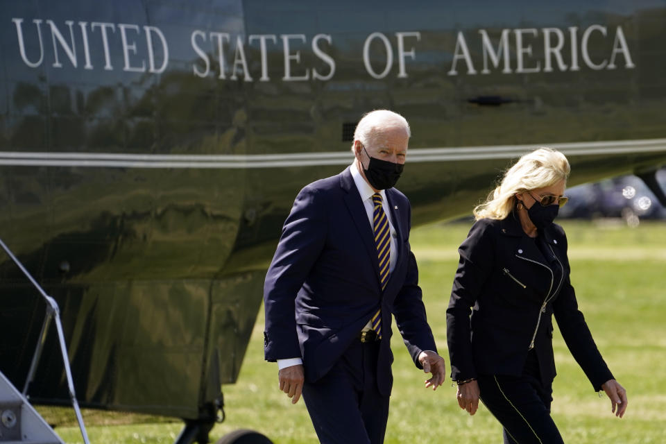 President Joe Biden walks from Marine One with first lady Jill Biden on the Ellipse on the National Mall after spending the weekend at Camp David, Monday, April 5, 2021, in Washington. (AP Photo/Evan Vucci)