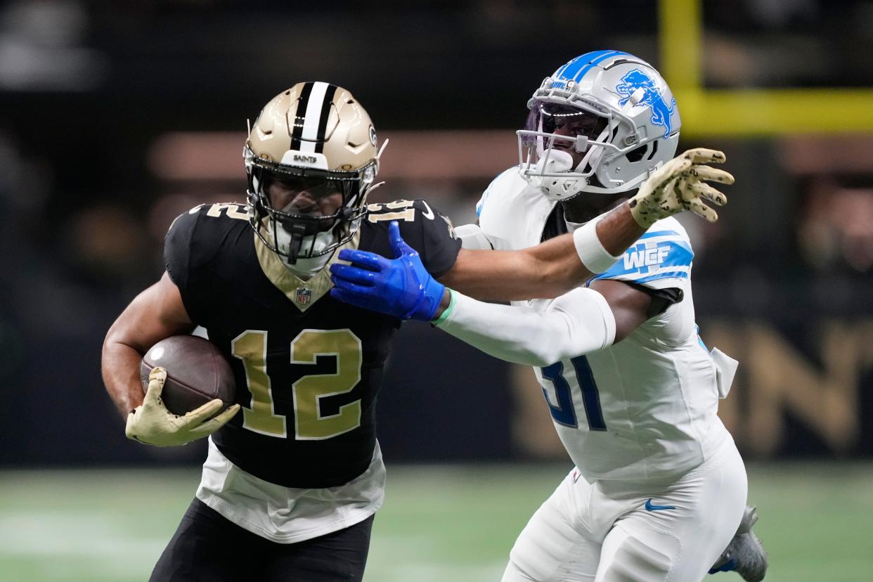 Saints wide receiver Chris Olave is tackled by Lions safety Kerby Joseph during the first half on Sunday, Dec. 3, 2023, in New Orleans.