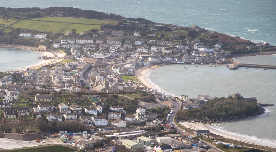 ISLES OF SCILLY, ENGLAND - FEBRUARY 23:  Hugh Town on St Mary's on the Isles of Scilly is seen from the air on February 23, 2017 in Cornwall, England. The temperate Isles of Scilly, with a population of just over 2200, are an archipelago of five main inhabited islands set amongst hundreds of smaller islands and rocky islets, located approximately 28 miles off the south western tip of the Cornish peninsula, making it the most westerly in England and the southernmost location of the United Kingdom. Originally, to sustain the islanders the Scillonian economy relied heavily on trade with the mainland, with industries such as seaweed harvesting, pilotage, smuggling, fishing, shipbuilding and more latterly, flower farming. However, more recently tourism has become the major part of the local economy, estimated to account for 85% of the islands' income and accounting for approximately 63% of all employment. Arrival to the cluster of low-lying islands is currently only by small plane from Exeter, Newquay or Land's End, or and only during the summer, by the passenger ferry Scillonian lll from Penzance.  (Photo by Matt Cardy/Getty Images)