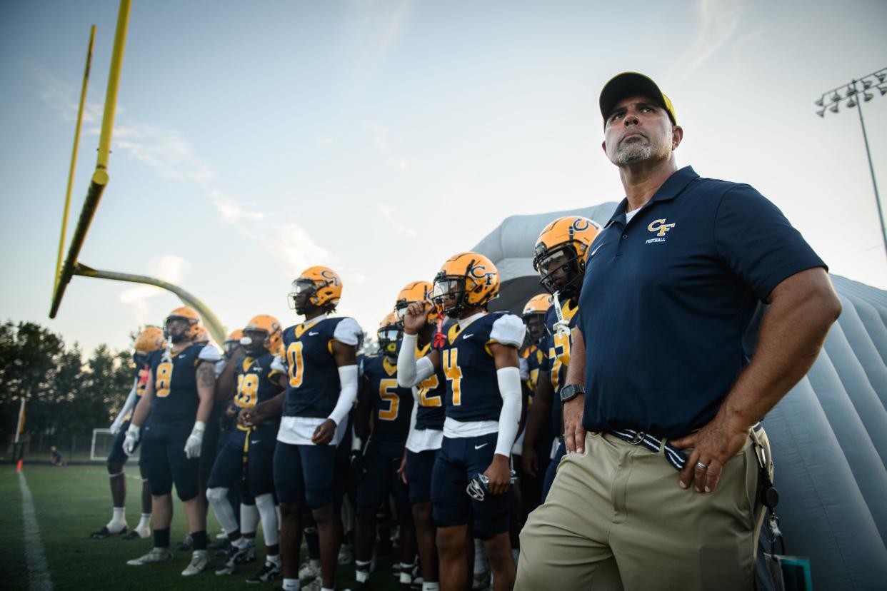 Cape Fear head football coach Jake Thomas stands with his team before heading out onto to the field for their game against Terry Sanford on Friday, Sept. 1, 2023, at Cape Fear High School.