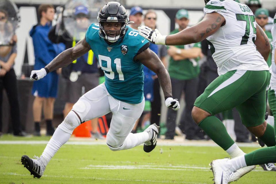 FILE - In this Oct. 27, 2019, file photo, Jacksonville Jaguars defensive end Yannick Ngakoue (91) rushes New York Jets quarterback Sam Darnold (14) during the first half of an NFL football game, in Jacksonville, Fla. Ngakoue made another public plea to be traded, this one on his 25th birthday. Ngakoue said in a Twitter post Tuesday, March 31, 2020,“ why hold a man from taking care of his family. It’s obvious my time is up in my current situation. Let’s both move on.” (AP Photo/Stephen B. Morton, File)