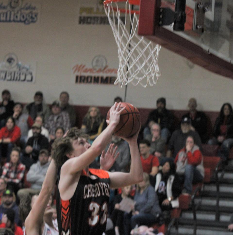 Cheboygan junior forward Ethan Gibbons (33) gets to the basket and scores during the second half at Onaway on Friday.