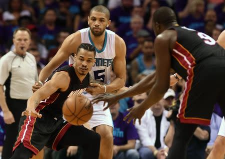 Apr 29, 2016; Charlotte, NC, USA; Miami Heat guard forward Gerald Green (14) reaches out to catch a pass from forward Luol Deng (9) during the first half in game six of the first round of the NBA Playoffs against the Charlotte Hornet at Time Warner Cable Arena. Mandatory Credit: Sam Sharpe-USA TODAY Sports