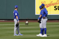 Chicago Cubs outfielders look at a goose standing in center field during the fourth inning of a spring training baseball game against the Arizona Diamondbacks Sunday, March 7, 2021, in Scottsdale, Ariz. The goose, who stayed in the outfield for most of the game, was joined by a second goose in the fifth inning. (AP Photo/Ashley Landis)