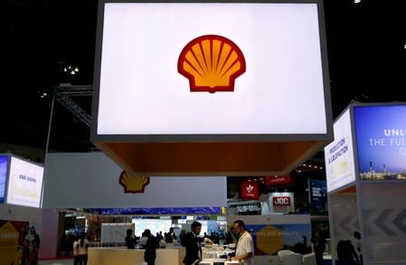 FILE PHOTO: Staff members work at the booth of Royal Dutch Shell at Gastech, the world's biggest expo for the gas industry, in Chiba