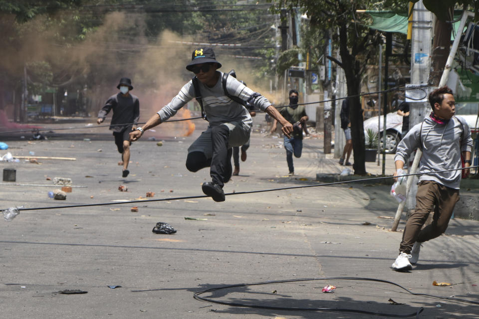 Anti-coup protesters run to avoid military forces during a demonstration in Yangon, Myanmar on Wednesday March 31, 2021. The Southeast Asian nation has been wracked by violence since the military ousted a civilian-led government on February 1 and began to forcibly put down protests. (AP Photo)