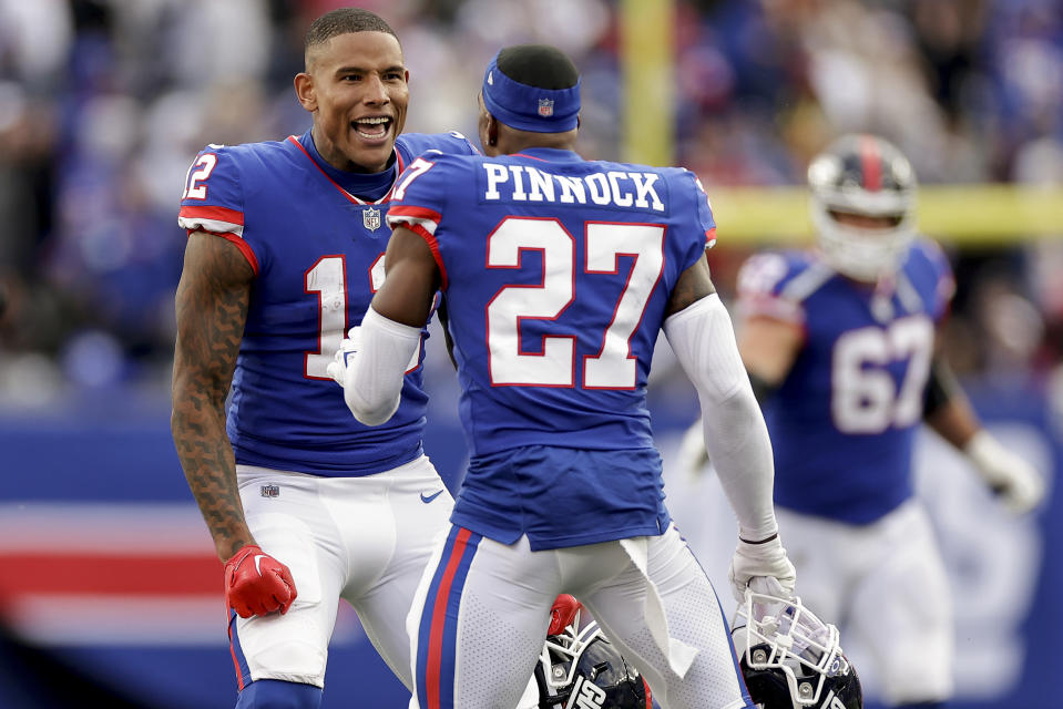 New York Giants tight end Darren Waller (12) and safety Jason Pinnock (27) react during the fourth quarter of an NFL football game against the Washington Commanders, Sunday, Oct. 22, 2023, in East Rutherford, N.J. (AP Photo/Adam Hunger)