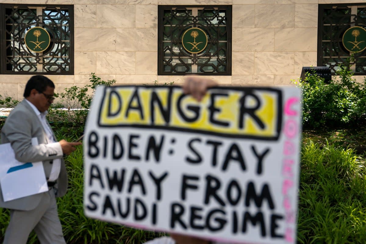 A protester holds a signs outside of the Saudi embassy in Washington, DC (Getty Images)