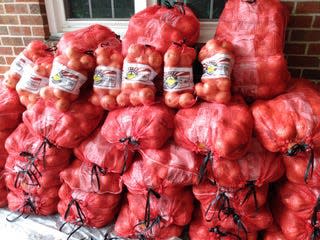 Vidalia onions are stacked and ready for pickup for an upcoming sale hosted by the Columbia Civitan Club.