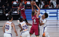 Miami Heat forward Kelly Olynyk (9) attempts a basket as Phoenix Suns' Cameron Johnson defends during the first half of an NBA basketball game, Saturday, Aug. 8, 2020 in Lake Buena Vista, Fla. (AP Photo/Ashley Landis, Pool)