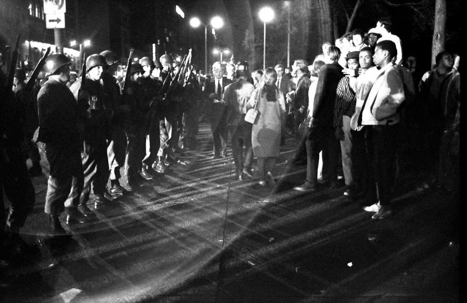 A line of National Guardsmen stand across from a group of protesters during widespread demonstrations at the Democratic National Convention in Chicago in 1968.