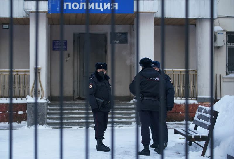 Police officers stand outside a police station where detained Russian opposition leader Navalny is being held, in Khimki
