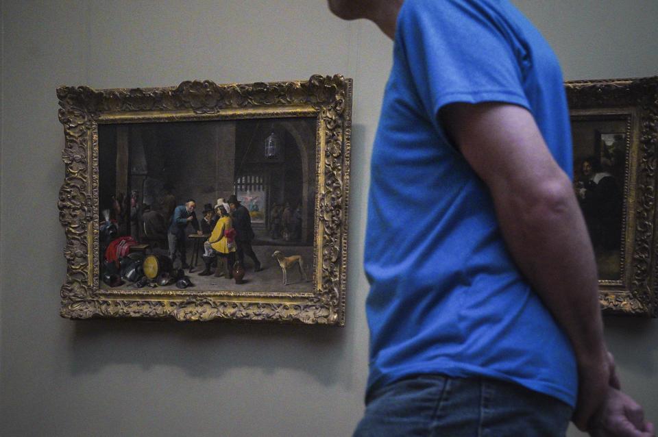 An oil on wood mid-17th century painting, left, by Flemish artist David Teniers the Younger, "Guardroom with the Deliverance of Saint Peter"—a 1964 gift by Edith Neuman de Végvár to the Metropolitan Museum of Art—is shown on exhibition at the museum Thursday, Sept. 1, 2022, in New York. The painting is among 53 works in the museum's collection, once looted during the Nazi era, but returned to their designated owners before being obtained by the museum through donation or sale. (AP Photo/Bebeto Matthews)