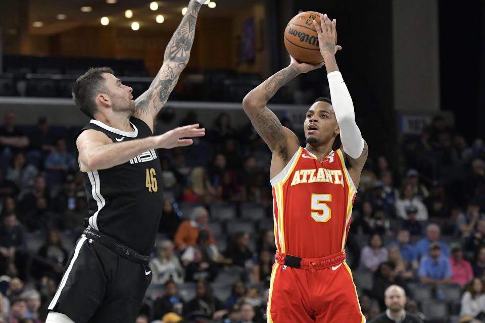 Atlanta Hawks guard Dejounte Murray (5) shoots against Memphis Grizzlies guard John Konchar (46) in the first half of an NBA basketball game Friday, March 8, 2024, in Memphis, Tenn. (AP Photo/Brandon Dill)