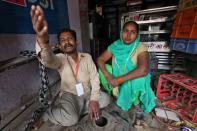 A man, who claims that his shop was attacked by a mob, cries in a riot affected area following clashes between people demonstrating for and against a new citizenship law in New Delhi