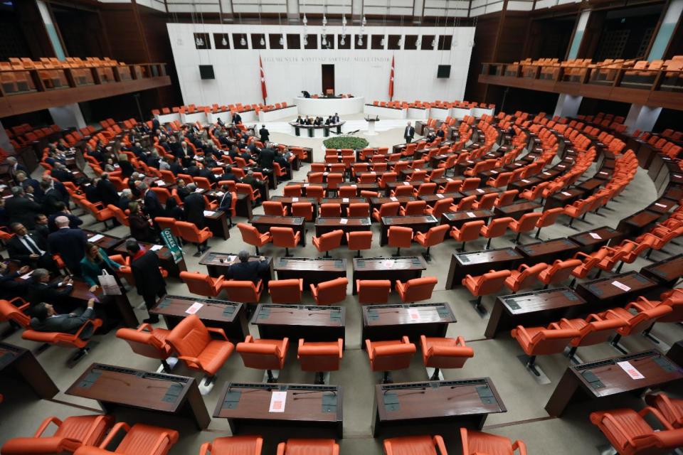 The opposition parties' lawmakers sit at the left with empty seats belonging to the ruling party at the right, at the beginning of a special session of the parliament in Ankara, Turkey, Wednesday, March 19, 2014. Turkey's opposition recalled parliament for an extraordinary session on Wednesday to initiate debate over corruption allegations against Prime Minister Tayyip Erdogan's government less than two weeks before local elections that are seen as a referendum over his rule.(AP Photo/Burhan Ozbilici)