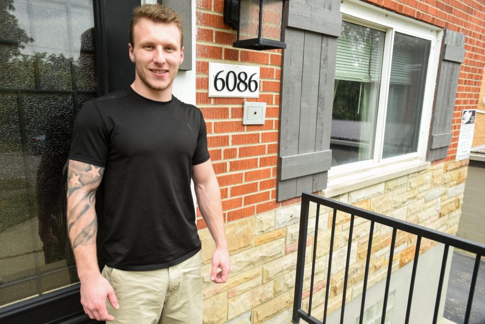 Aj Penley stands outside of his apartment for a portrait. Penley continues to work during the COVID-19 pandemic.