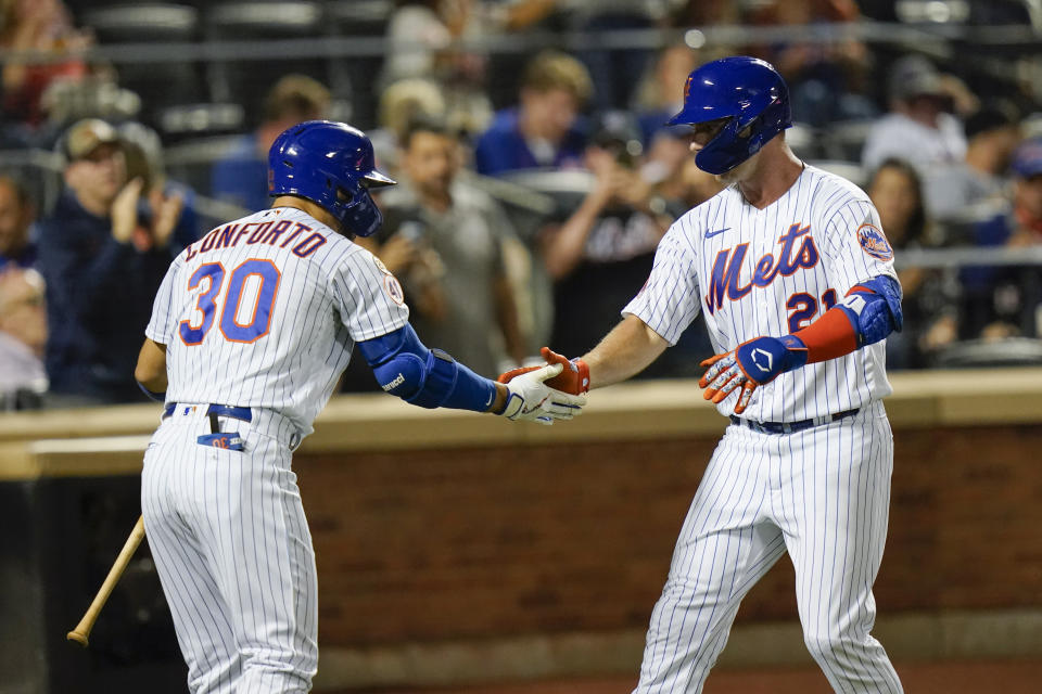 New York Mets' Michael Conforto, left, celebrates with New York Mets' Pete Alonso, wearing Pittsburgh Pirates Hall of Fame player Roberto Clemente's No. 21 on Roberto Clemente Day, after Alonso hit a home run during the second inning of a baseball game against the St. Louis Cardinals Wednesday, Sept. 15, 2021, in New York. (AP Photo/Frank Franklin II)
