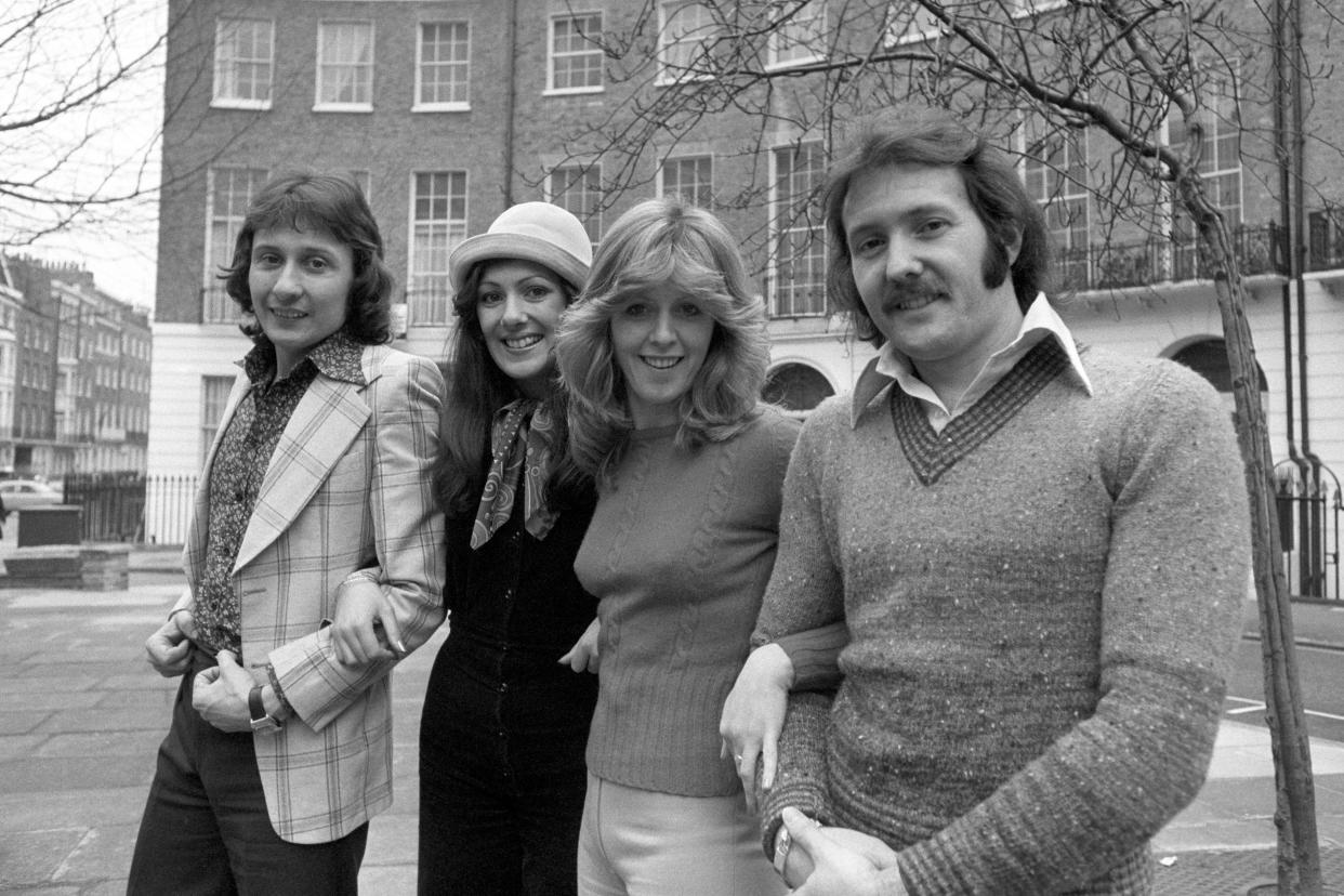 Eurovision winners Brotherhood of Man standing outside a row of houses
