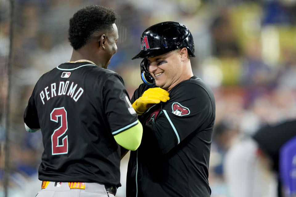 Arizona Diamondbacks designated hitter Joc Pederson celebrates his solo home run with Geraldo Perdomo during the ninth inning of a baseball game against the Los Angeles Dodgers, Tuesday, July 2, 2024, in Los Angeles. (AP Photo/Ryan Sun)