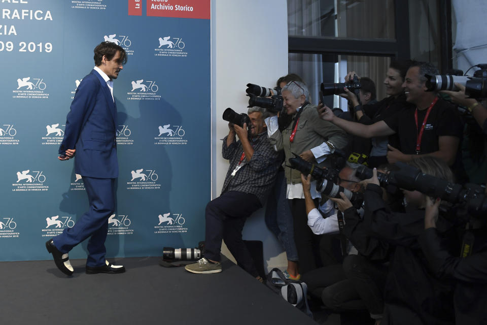 File - Actor Johnny Depp poses for photographers at the photo call for the film 'Waiting for the Barbarians' at the Venice Film Festival. The 77th Venice Film Festival will kick off on Wednesday, Sept. 2, 2020, but this year's edition will be unlike any others. Coronavirus restrictions will mean fewer Hollywood stars, no crowds interacting with actors and other virus safeguards will be deployed. (Photo by Arthur Mola/Invision/AP, File)