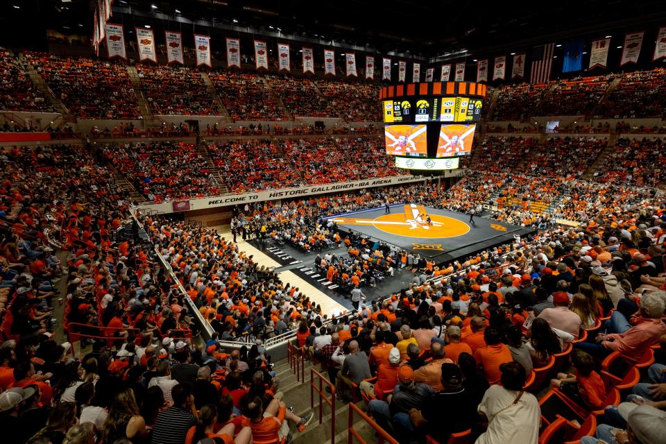 Iowa's Drake Ayala wrestles Oklahoma State's Troy Spratley at 125 pounds in front of a sold-out crowd Sunday at Gallagher-Iba Arena in Stillwater.