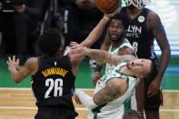 Brooklyn Nets' Spencer Dinwiddie (26) shoots against Boston Celtics' Daniel Theis during the first half of an NBA basketball game, Friday, Dec. 25, 2020, in Boston. (AP Photo/Michael Dwyer)
