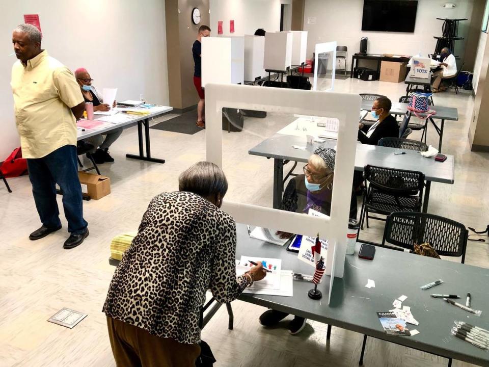 A voter checks in at the West Charlotte Community Center Precinct 25 on Senior Drive before voting on Tuesday, May 17, 2022.