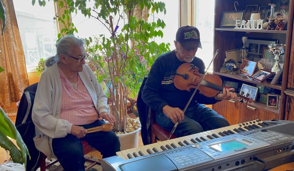 Dorothy and Angus Beaulieu playing a song in their home in Fort Resolution, N.W.T. on June 2, 2021.