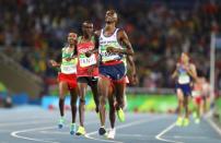 2016 Rio Olympics - Athletics - Final - Men's 10,000m Final - Olympic Stadium - Rio de Janeiro, Brazil - 13/08/2016. Mo Farah (GBR) of Britain celebrates winning the men's 10,000m final. REUTERS/Lucy Nicholson