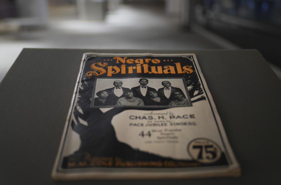 One of the only surviving books of gospel spirituals composed and published by Charles Henry Pace, part of his archive together with photo negatives of sheet music and printing places, is seen at the University of Pittsburgh on Tuesday, Feb. 28, 2023, in Pittsburgh. A project led by the university is highlighting Pace as one of the pioneers of traditional African American gospel with his publishing company being one of the nation's first to print and disseminate Black gospel music. (AP Photo/Jessie Wardarski)