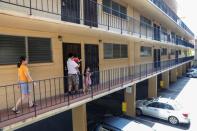 Judith and Jose Ramirez walk with their daughters to their unit in an apartment complex in Honolulu