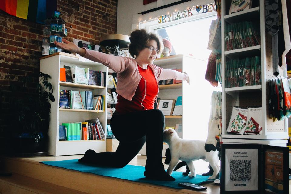 Puppies interact with yoga instructor Sarah Judd during a puppy yoga session with Sarah’s Yoga Studio on Feb. 18, 2023 at Skylark Bookshop in Columbia, Mo. 