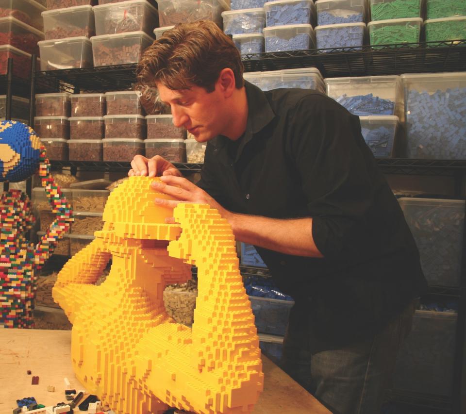 Nathan Sawaya working with Legos