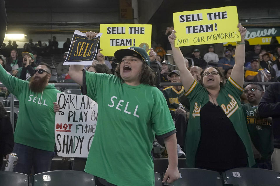 Oakland Athletics fans hang yell to protest the team's potential move to Las Vegas and to call for team owner John Fisher to sell the team during the sixth inning of a baseball game between the Athletics and the Cincinnati Reds in Oakland, Calif., Friday, April 28, 2023. (AP Photo/Jeff Chiu)