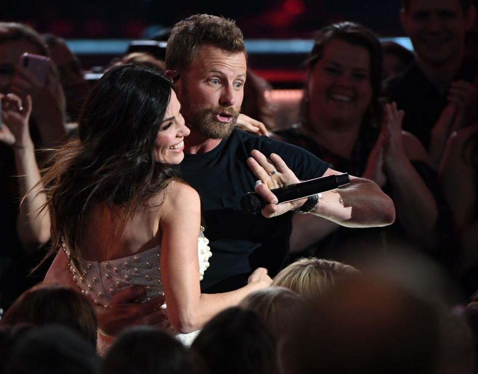 <p>Who could resist a kiss from the “Woman, Amen” singer? <a href="https://www.countryliving.com/life/entertainment/a25053556/dierks-bentley-wife-cassidy-black/" rel="nofollow noopener" target="_blank" data-ylk="slk:His wife, Cassidy Black,;elm:context_link;itc:0;sec:content-canvas" class="link ">His wife, Cassidy Black,</a> apparently! While performing his hit song, he went in for a smooch from Cassidy. She eventually obliged, but looked a little surprised and embarrassed about the PDA.</p>