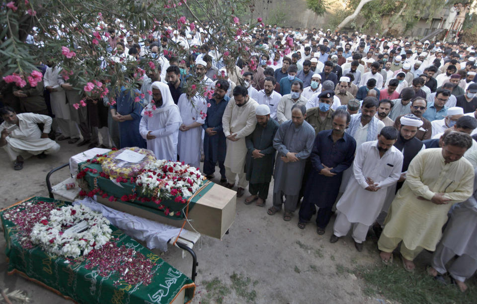 People attend the funeral for victims of the crash of a state-run Pakistan International Airlines plane on Friday near the southern port city of Karachi, in Rawalpindi, Pakistan, Monday, May 25, 2020. (AP Photo/Anjum Naveed)