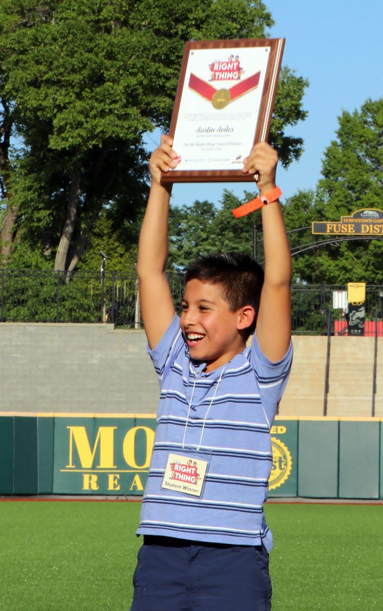 Austin Aviles, a fourth-grader at Gaston County Virtual Academy, happily holds up his award during a "Do the Right Thing" ceremony held on Tuesday, May 17, at CaroMont Health Park.