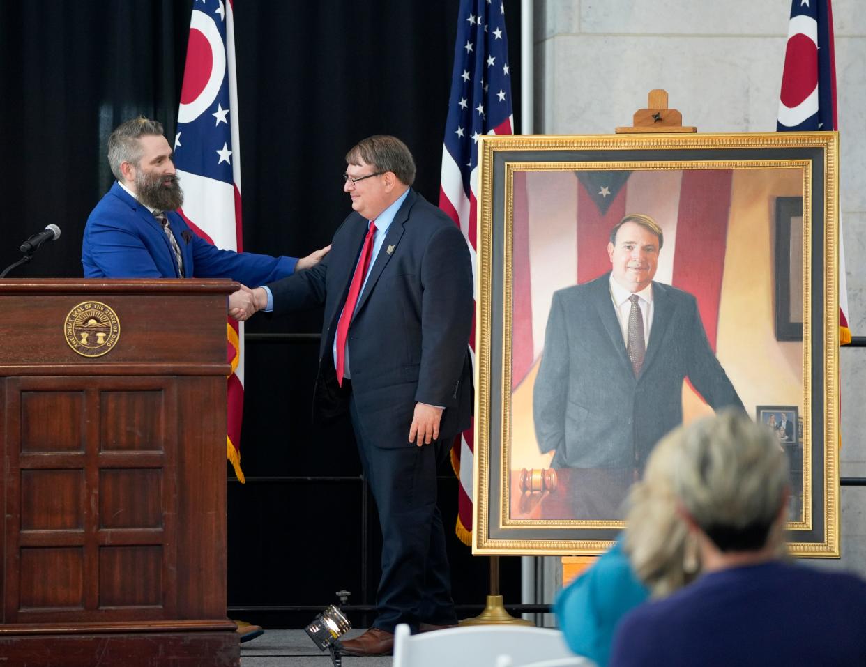 Former Ohio Senate President Larry Obhof shakes hands with artist Paul Wyse after Wyse's portrait of Obhof was unveiled in the atrium of the Ohio Statehouse on Wednesday.