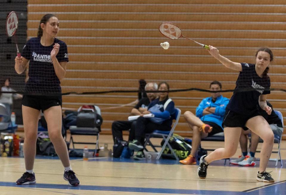 Miami Palmetto Senior High School’s Isabella Reale, left, and Penelope Murray return a shot during their Girls’ doubles badminton championship at G Holmes Braddock Senior High on Tuesday, April 18, 2023, in Miami, Fla.