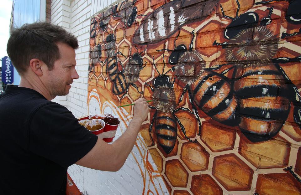 Gastonia City Council has formed a new committee that will focus on the arts as an economic tool. In this 2017 Gazette file photograph, artist Matt Willey works on a mural above the Hive Design business on West Main Avenue in downtown Gastonia.