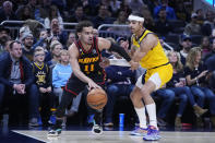 Atlanta Hawks' Trae Young (11) goes to the basket past Indiana Pacers' Andrew Nembhard during the first half of an NBA basketball game Friday, Jan. 13, 2023, in Indianapolis. (AP Photo/Darron Cummings)