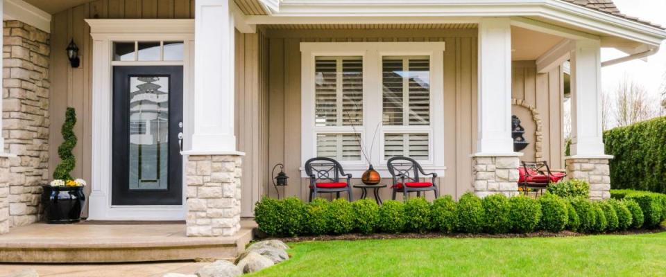 A home's front lawn with sizeable, established greenery