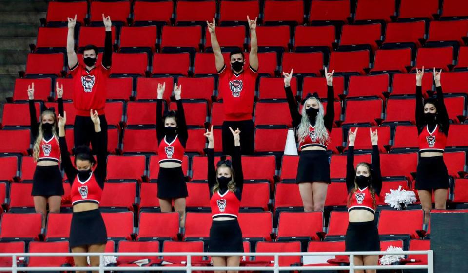 N.C. State cheerleaders watch the Wolfpack make a free throw during the first half of N.C. State’s game against Pittsburgh at PNC Arena in Raleigh, N.C., Sunday, February 28, 2021.