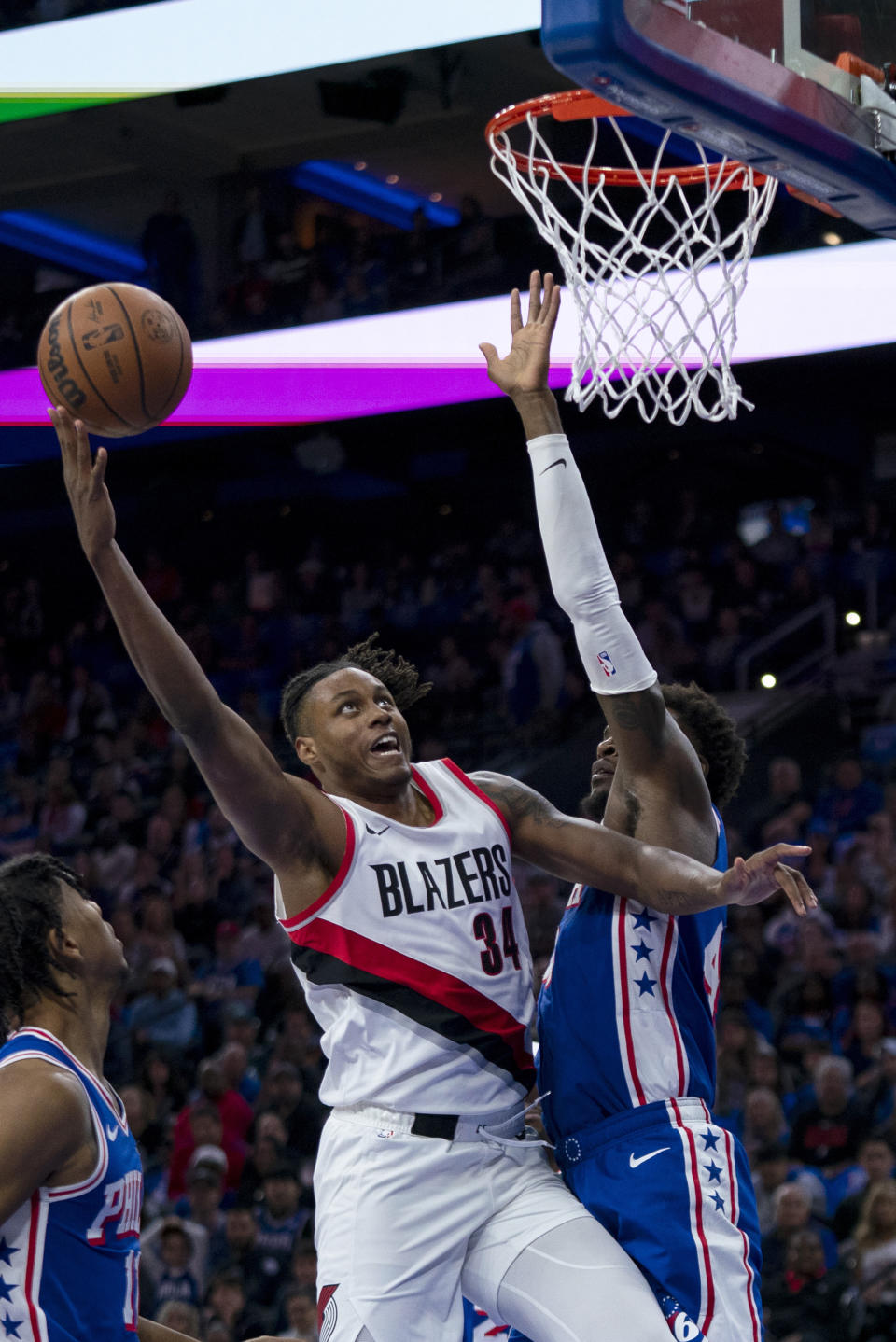 Portland Trail Blazers' Jabari Walker, left, shoots against Philadelphia 76ers' Paul Reed, right, during the first half of an NBA basketball game, Sunday, Oct. 29, 2023, in Philadelphia. (AP Photo/Chris Szagola)